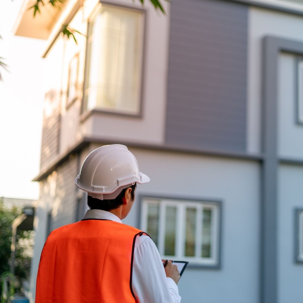 Technician inspecting residential HVAC system during commissioning in Arizona home